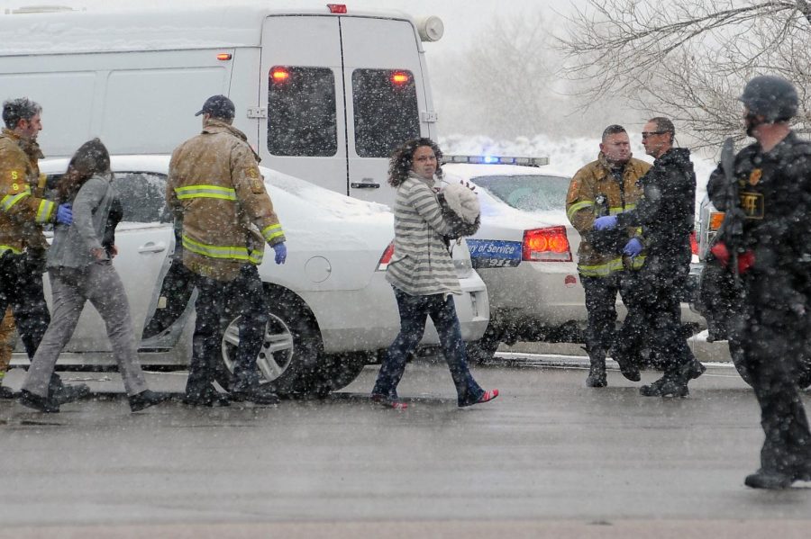 People are escorted away from the scene by police after a gunman opened fire at a Planned Parenthood facility on Centennial Boulevard in Colorado Springs, Colo., on Friday, Nov. 27, 2015. The gunman was captured alive. (Daniel Owen/Colorado Springs Gazette/TNS)