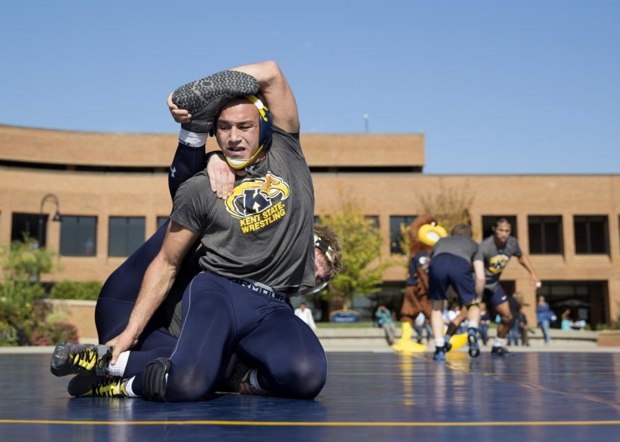 Freshman Shane Mast practices during the third annual outdoor Kent State Wrestling practice in Risman Plaza. Oct. 12, 2015.