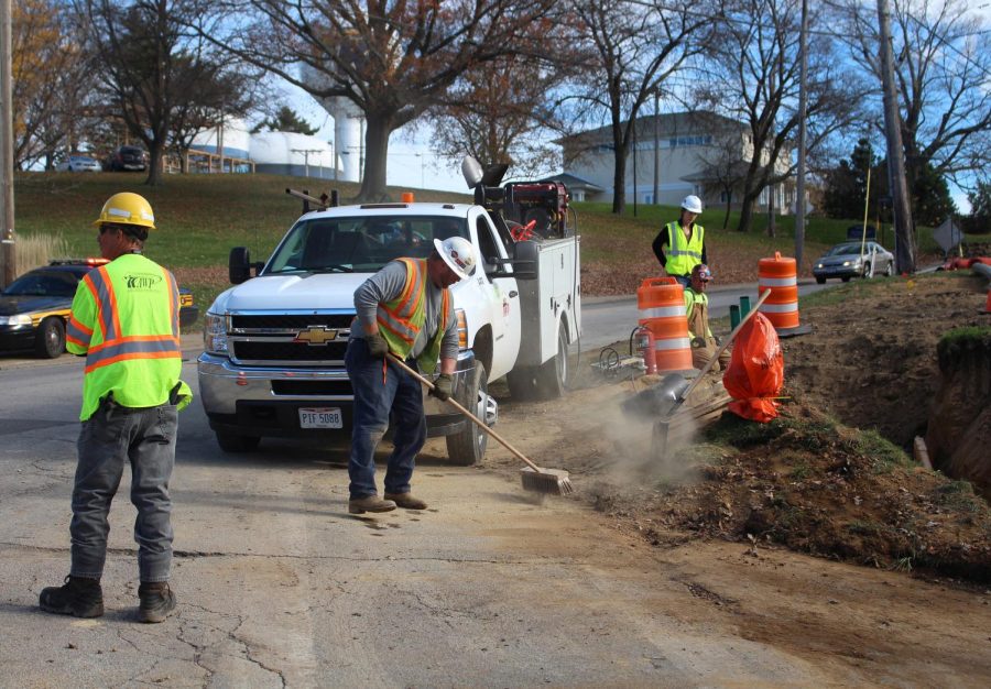 Members of the Area Wide Protective Street construction company dust off the road and work in the ditch on the corner of Summit and Lincoln on Monday, Nov. 9, 2015.