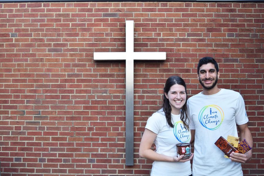 Co-chair ambassadors Veronica Musser and Eric Abowd stand outside of the Newman Center wearing their “I Am Climate Change” campaign shirts and holding fair trade hot chocolate and chocolate bars.