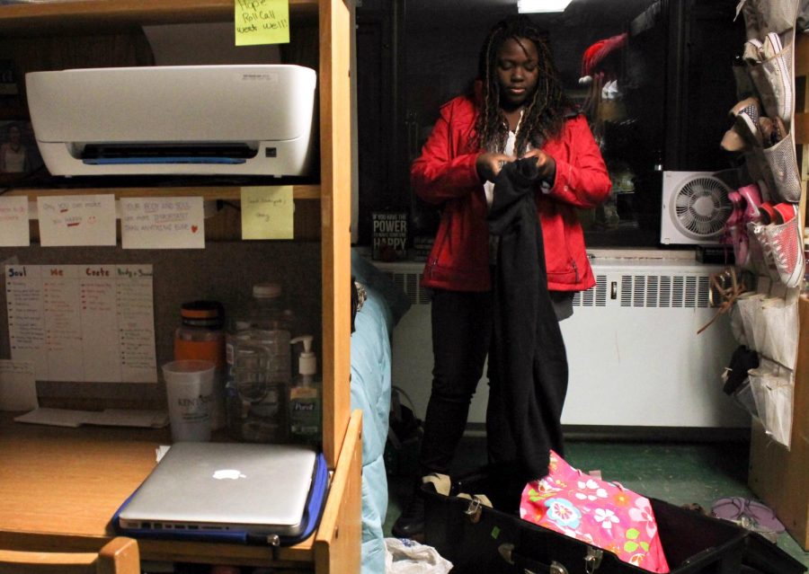 Keondra Wright, a freshman theater studies major, packs clothes in preparation for winter break.