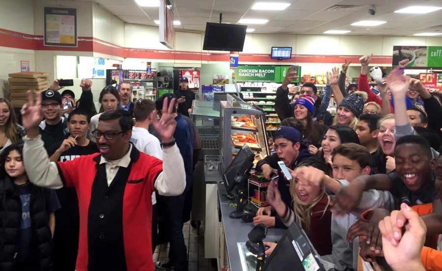 M. Faroqui, left, who sold the Powerball winning ticket at a 7-11 in Chino Hills, Calif., reacts with the crowd in the store on Wednesday, Jan. 13, 2016.