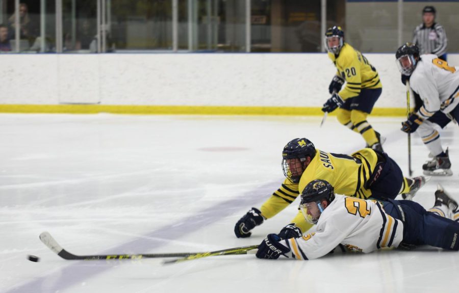 Kent State senior forward Jared Fielden dives toward the puck to get it out of the zone against the University of Michigan Dearborn at home on Friday, Feb. 5, 2016.