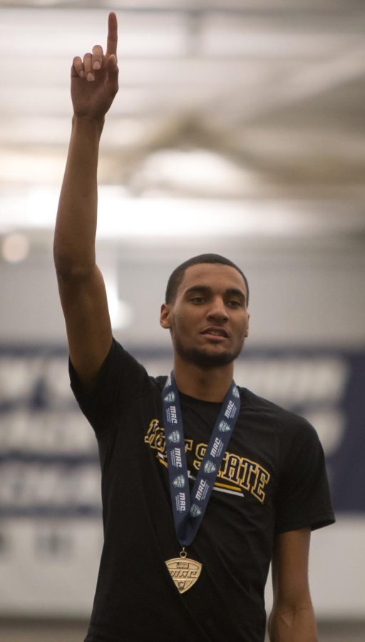 Senior Roosevelt Dotson raises his finger after receiving his first place medal in the high jump competition during the MAC Indoor Track and Field Championship at University of Akrons Stile Athletic Field House on Saturday, Feb. 27, 2016.
