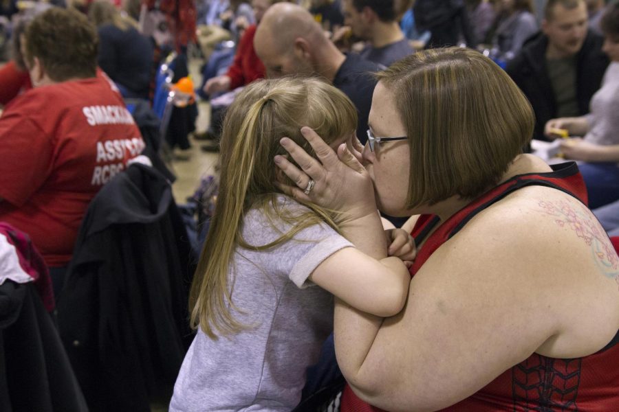 Sarah Dombrosky kisses her daughter, Olivia, during halftime of the Rubber City Rollergirls’ first bout of the season at the John S. Knight Center in Akron, Ohio on Saturday, Feb. 6, 2015. 
