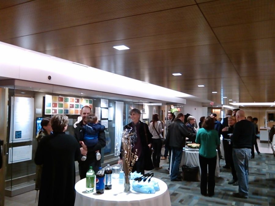 Visitors at the reception gather together to view the exhibit in the MuseLab on Thursday, Feb. 4.