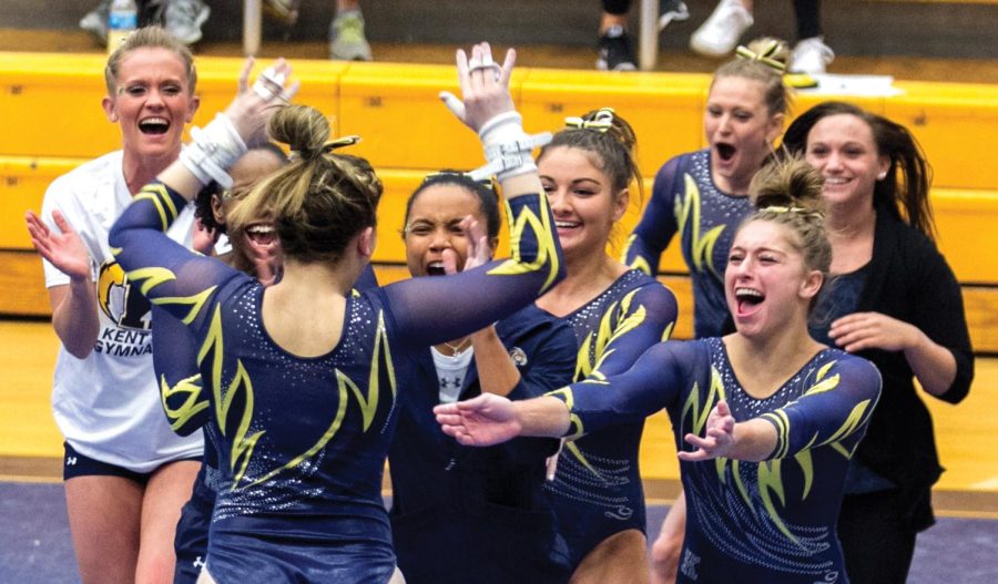 Sophomore Ali Marrero celebrates with her Kent State gymnastics teammates after her performance on the bars. The Flashes took second place at the tri-meet with George Washington and Northern Illinois University on Sunday, Feb. 7, 2016 at the M.A.C. Center.