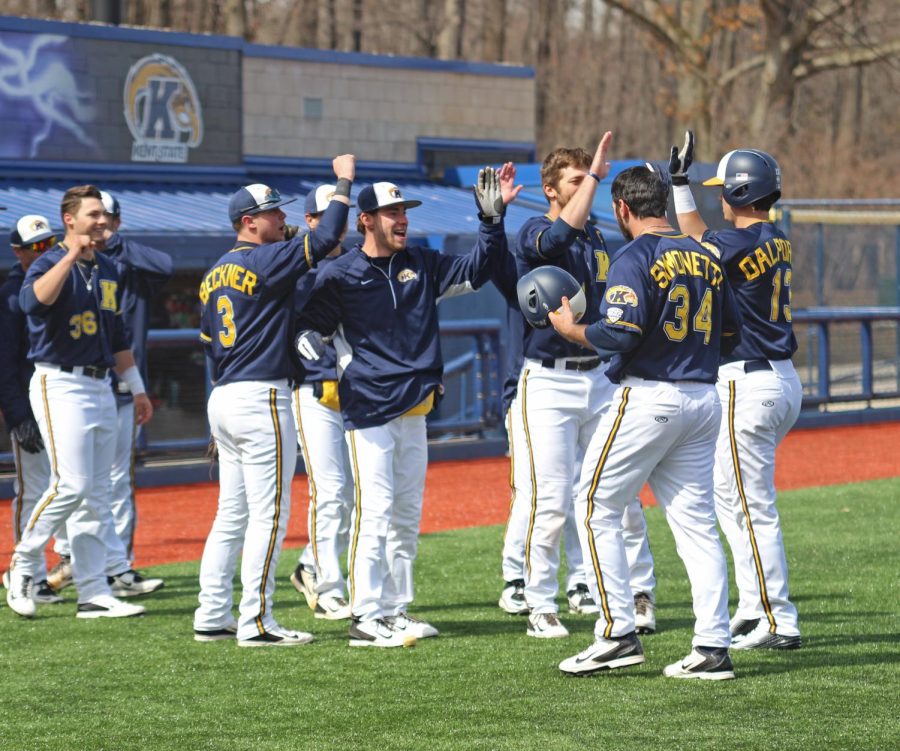 The+Kent+State+baseball+team+congratulates+catcher%2Futility+Tim+DalPorto+on+his+first+collegiate+home+run+in+a+doubleheader+Eastern+Michigan+University+on+Sunday%2C+March+29%2C+2015.+The+Flashes+beat+the+Eagles+8-6+in+the+first+game.