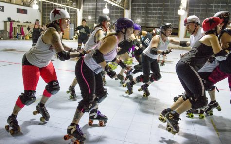The Rubber City Rollergirls prepare for the upcoming season by practicing jamming and blocking on Wednesday, Nov. 4, 2015, in Akron, Ohio. 