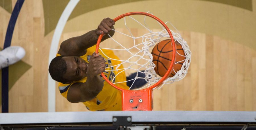 Redshirt junior forward Jimmy Hall dunks during the first half against Akron at James A. Rhodes Arena on Friday, March 4, 2016. The Flashes lost 60-74.