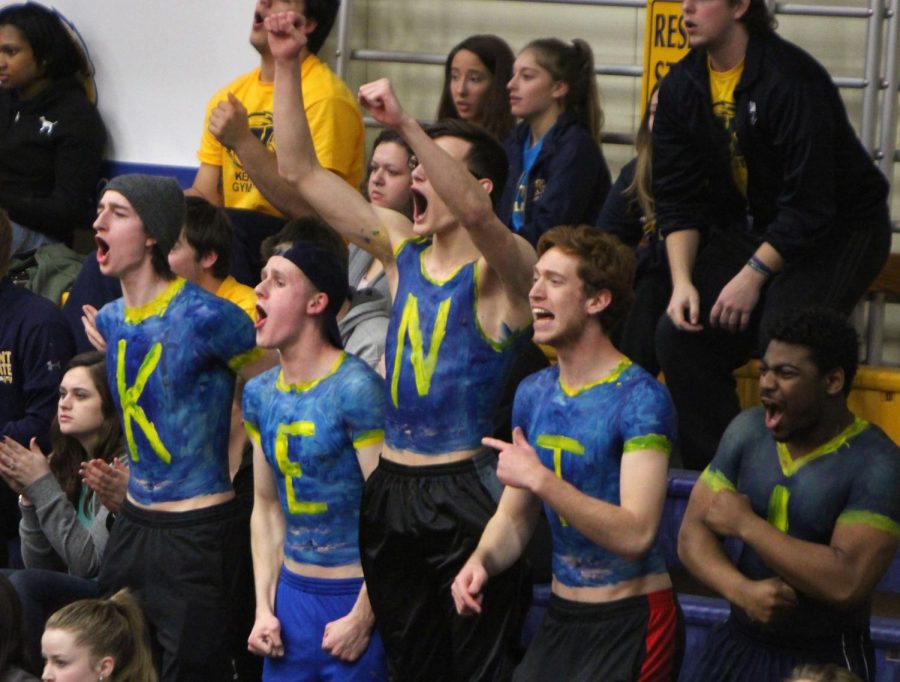 (from left) Freshman Griffin Rath, sophomore Nick Larson, freshman Seth Ference, sophomore Matt Grissom and sophomore Michael Parker celebrate in the student section as Kent State scores against BGSU in the M.A.C. Center on Monday, Mar. 7, 2016.
