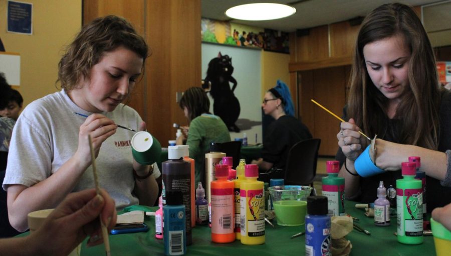 Sophomore communication students, Brooke Davis and Jana Life paint flower pots in the Nest on March 14, 2016.