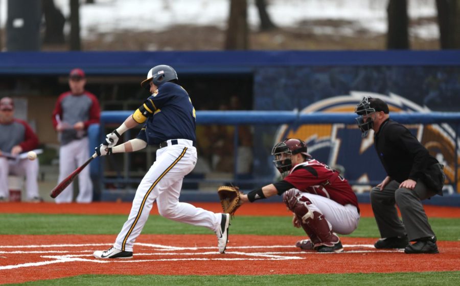 Freshman Dylan Rosa swings at a ball that would be a homerun for the Flashes only point of the game. The Flashes lost to Rider University 3-1. March. 15, 2015.