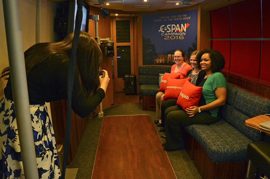 C-Span marketing representitive, Chellie Zou takes a photo of Rebecca Capler, Katie Goldring, and Dasha Harris. The C-Span bus stopped by campus, March 15, 2016, to inform students about the upcoming election and candidates.