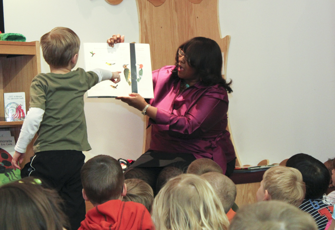 Iris Harvey, vice president for university relations, reads to children from the Child Development Center at the University Library on Thursday. Photo by Anthony Vence.