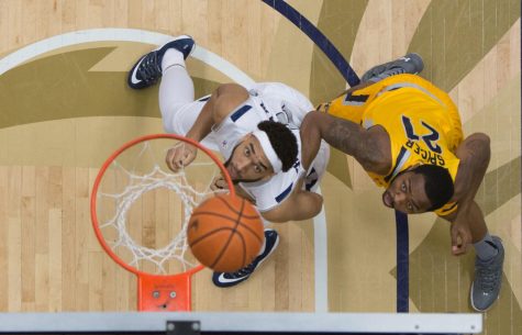 Senior center Khaliq Spicer fights for position against University of Akron’s sophomore forward Kwan Cheatham at James A. Rhodes Arena on Friday, March 4, 2016.