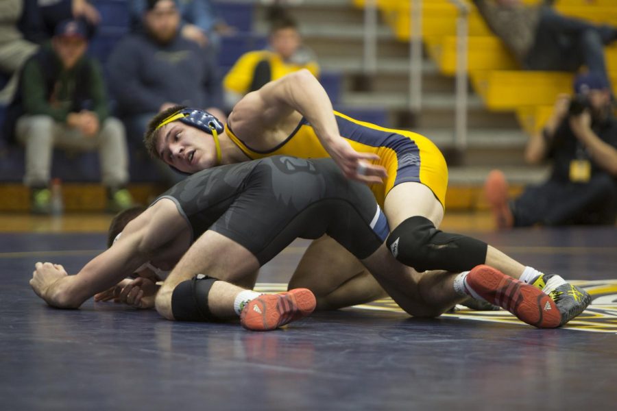 Kent State fifth year senior wrestler Ian Miller fights for position against an Old Dominion University wrestler during a meet at the M.A.C. Center on Sunday, Jan. 24, 2016. The Flashes won the Meet 25-13.