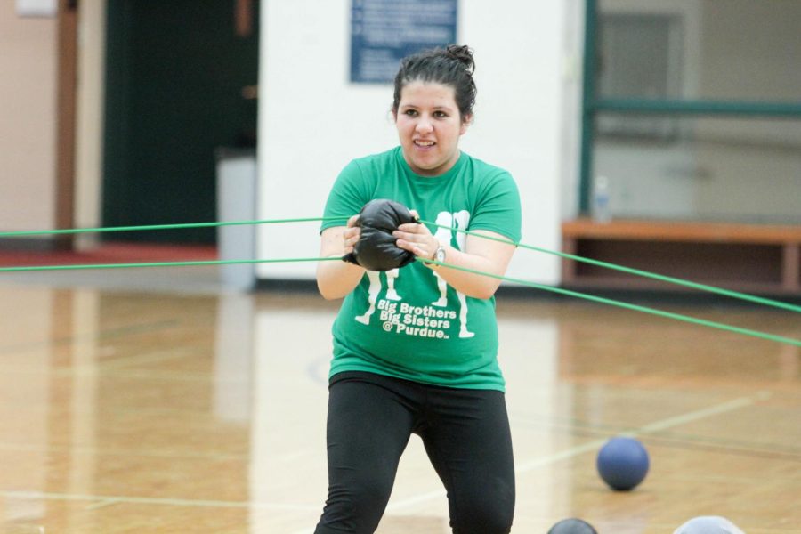 Graduate student Priscilla Gaona uses the slingshot during Life Size Board Game Night in the Student Recreation and Wellness Center on Friday, March 11, 2016.