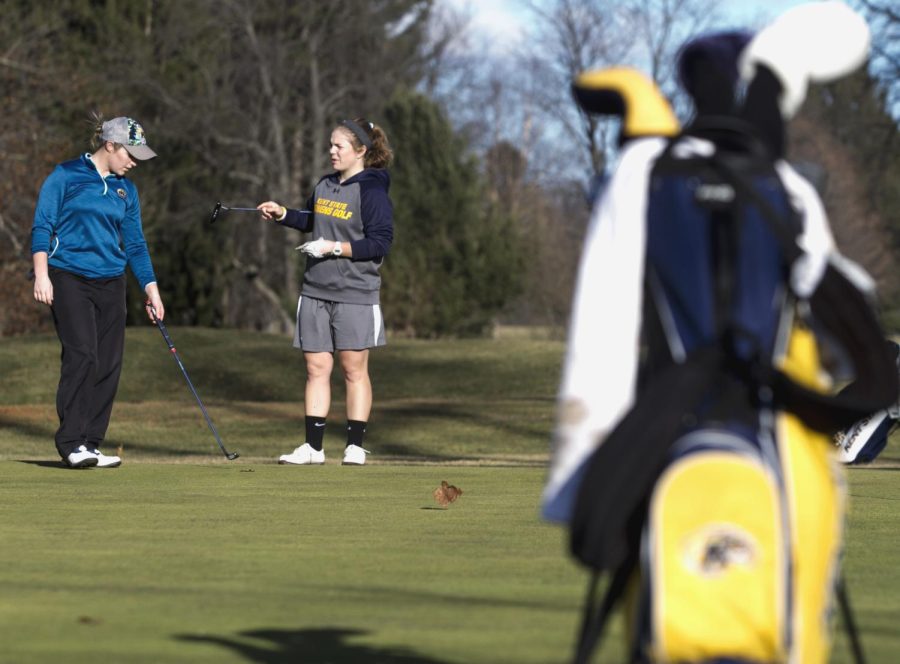 Senior Josée Doyon and junior Maddy Mullins practice at the Kent State Golf Course on Wednesday, Feb. 3, 2016.