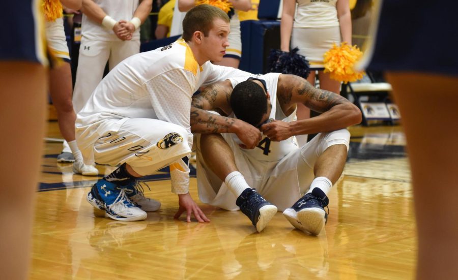 Junior guard Jon Fleming consoles senior Chris Ortiz after Kent State was eliminated by Bowling Green from the MAC Tournament, 70-69, on Monday, March 7, 2016 at the M.A.C. Center.