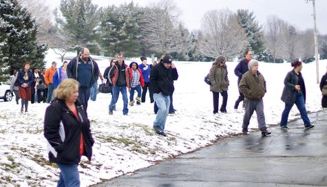 Parents walk from the parking lot to Franklin School Elementary School to wait for their children to be released on Friday, March 4, 2016.
