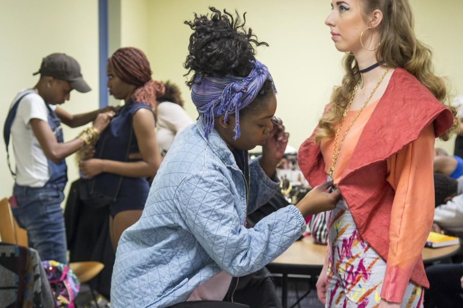 Designer Keama Garrett makes last minute adjustments to her model Sarah Grages before the Rock The Runway Fashion Show on Saturday March 7, 2015. The name of this collection was “Jama”.