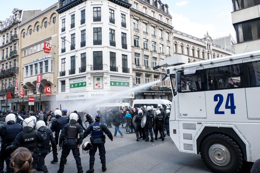 Police fire a water cannon at protesters who gathered at a memorial site for the victims of the March 22 terrorist attacks in Brussels on Sunday, March 27, 2016. 