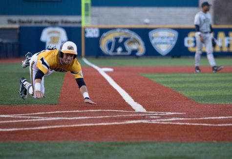 Josh Hollander slides into home plate scoring the first run in the home opener game against the University of Pittsburgh on Wednesday, March 16, 2016. The Flashes lost 9-4.