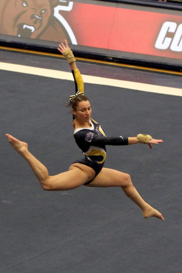 Junior Samantha Gordon leaps across the floor in the senior night competition against Cornell on March 5. The Goldend Flashes beat the Cornell Big Red Bears 196.000-193.175