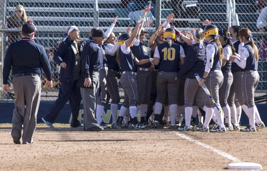 Teammates greet sophomore Holly Speer (#10) in celebration after her three-run home run ended the second game of the double-header with Central Michigan University in the 6th inning at the Diamond at Dix Stadium on Saturday, March 26, 2016. The Flashes won 9-0.