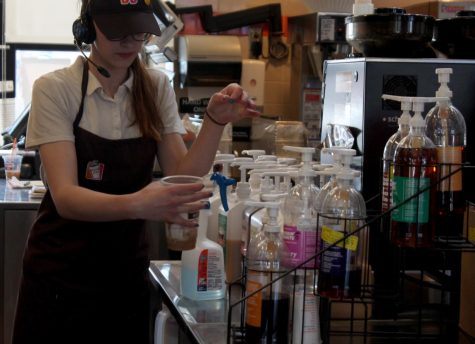 Kent State alumni and Dunkin Donuts employee Adrianna Swaney prepares a drink for a customer on Saturday, April 16, 2016. 