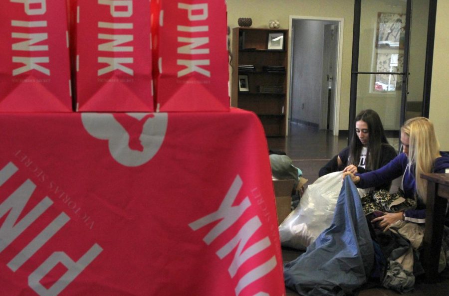 Sam Arslanian (left) and Juli Houck, campus representatives for Victorias Secret, sort through donations for the PINK Gimme Good Vibes Initiative in University Oaks Clubhouse on Wednesday, April 13, 2016.