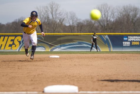Junior infielder Maddy Grimm races towards third base as the ball flies foul at the Diamond at Dix Stadium on Wednesday, April 13, 2016. Kent State defeated Ohio University, 5-4, in 2 extra innings.