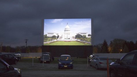 A woman sits in her car while the national anthem plays on the screen at the Midway Drive In on Friday April 29, 2016. While drive ins may seem like a thing of the past, those still open are thriving.