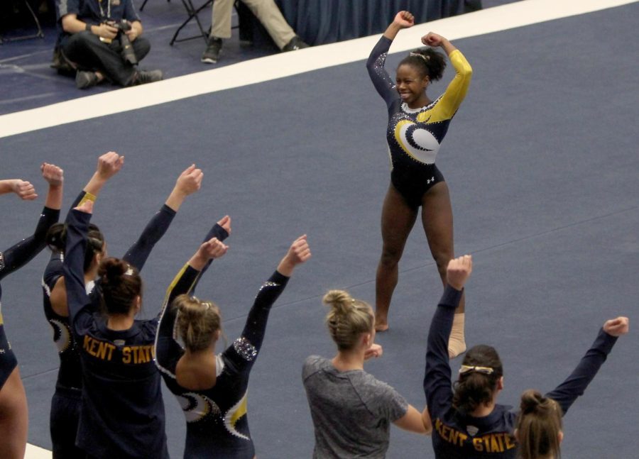 Teammates dance along with junior Samantha Gordon as she performs her floor routine in a meet against Cornell University on March 6, 2016. Kent State beat Cornell 196.000-193.175.