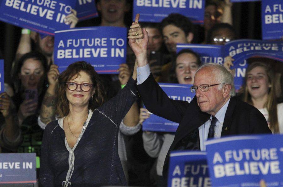Susan Sarandon, left, brings Bernie Sanders onto the stage at Drexel University in Philadelphia on Monday, April 25, 2016.