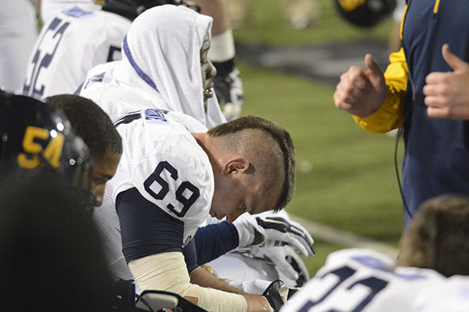 Kent State junior defensive line Nate Terhune hangs his head after Bowling Green scored its second touchdown to make it 14-0 at Doyt Stadium on Wednesday, Nov. 12, 2014. 