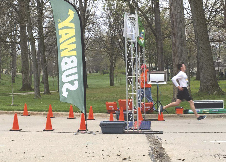 Mark Buzzy , a junior business management major, crosses the finish line during the first race of the Freedom Run Series on Saturday, April 30, 2016. Buzzy placed first with a time of 18:37.