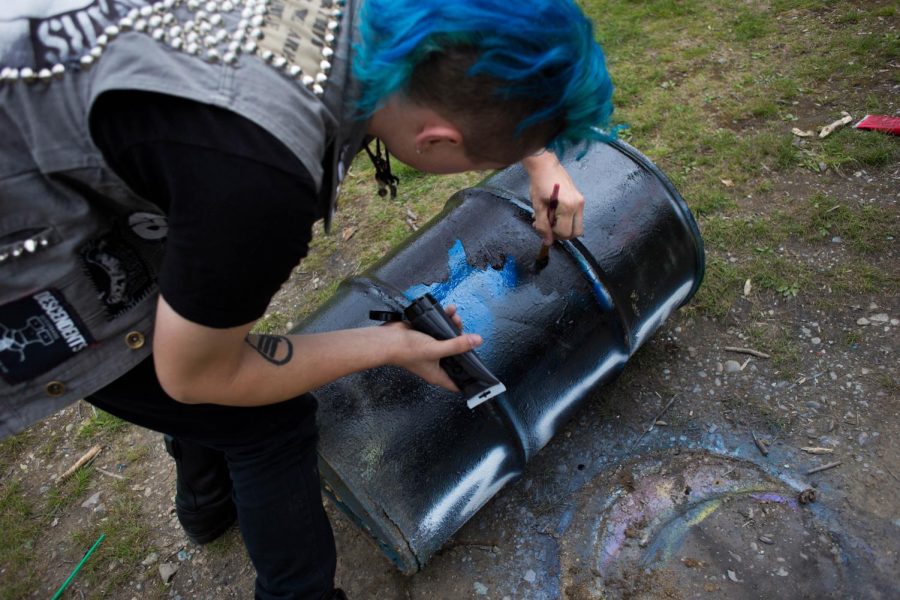 Eslah Attar / The Kent Stater Ritchie Allen, sophomore sociology major, covers up the remaining blue paint on the trash can with the Black Lives Matter acronym on May 4, 2016. Allen came rushing to the rock after reading a tweet that said the rock was covered back in Blue Lives Matter for cops.