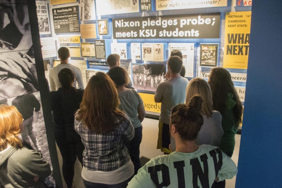 Kent State students view the wall of newspapers and articles inside the May 4 Visitor Center that showed immediate reaction and repercussion to the May 4, 1970 shooting.