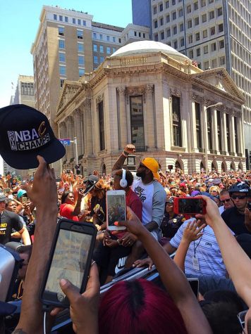LeBron James of the Cleveland Cavaliers waves to the crowd of spectators gathered in downtown Cleveland, Ohio, during the teams victory parade on Wednesday, June 22, 2016.