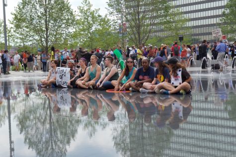 A group of peaceful protesters sit in the downtown Cleveland Public Squares fountain on Thursday, July 21, 2016.