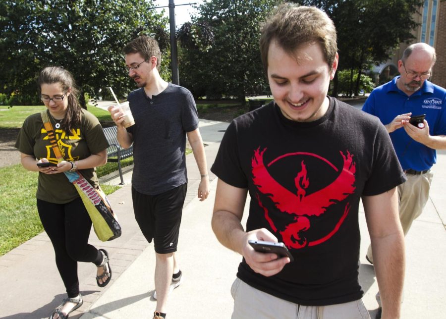 (From left to right) Senior fine arts major Melissa Mendelson, Kent State Pokemon League director of tournaments Patrick Brett, junior computer sciences major Max Eisenloeffel and Kent State employee Gaylen Moore tour the main campus playing Pokemon Go on Thursday, Aug. 25, 2016.