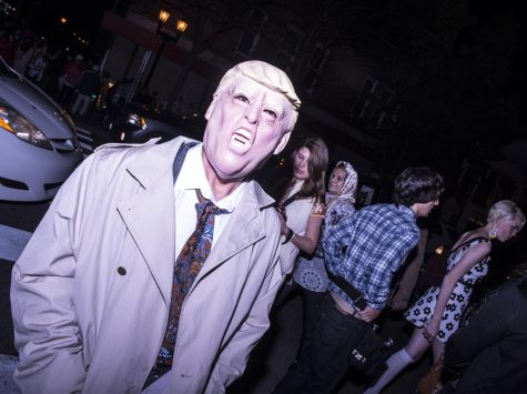 Akron resident Larry Steele crosses the street in his Donald Trump costume during the Halloween festivities downtown on Saturday, Oct. 29, 2016.