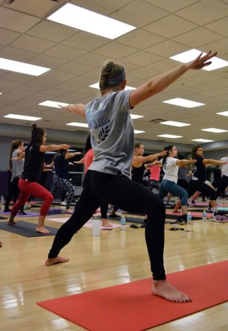  Allison Wanci, a Group X yoga instructor takes a step away from her normal routine to lead a class for the PINK yoga event on Wednesday, Oct. 5, 2016, at the Kent State Student Recreation and Wellness Center, with 70 girls in attendance.