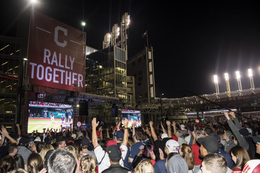 People watching the World Series on the jumbotron between the Cleveland Indians and the Chicago Cubs near Progressive Field in Cleveland, Ohio, on Tuesday, Nov. 1, 2016