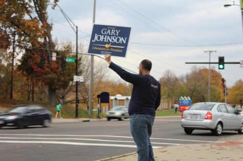 John Jancsurak holds up a Gary Johnson sign outside of the United Church of Christ on Tuesday, Nov. 8, 2016.