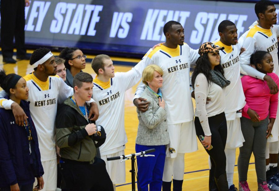 Kent State President Beverly Warren stands with the mens basketball team and members of the audience during the national anthem as a statement of unity in the face of political turmoil on Wednesday, Nov. 16, 2016.