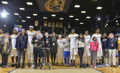Members of the Kent State mens basketball team and members of the crowd stand for the national anthem before the teams home opener against Mississippi Valley State University on Wednesday, Nov. 16, 2016. The team invited members of the crowd of a different race on to the floor as a sign of unity.