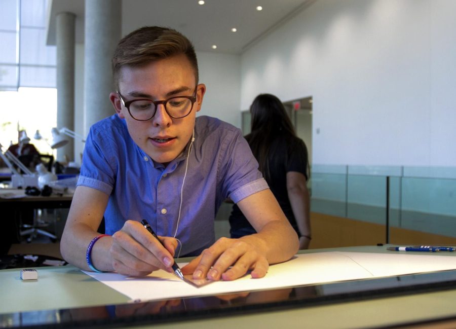 Freshman architecture major Jonathan Bonezzi gets to work at his assigned work station in the new College of Architecture and Environmental Design building on Monday, Aug. 29, 2016.
